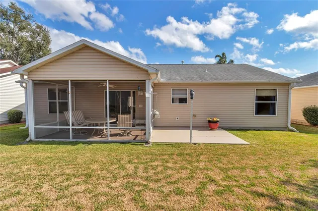 a view of a house with backyard and sitting area