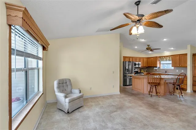 a living room with furniture and kitchen view