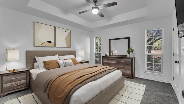 a bedroom with a large bed and a chandelier