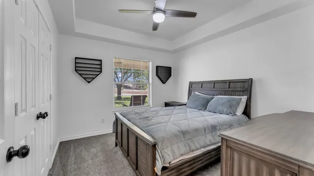 a bedroom with a bed and a chandelier