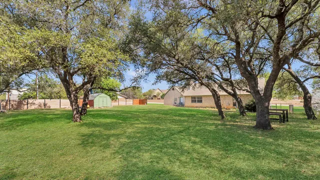 an aerial view of a house with a yard and garden