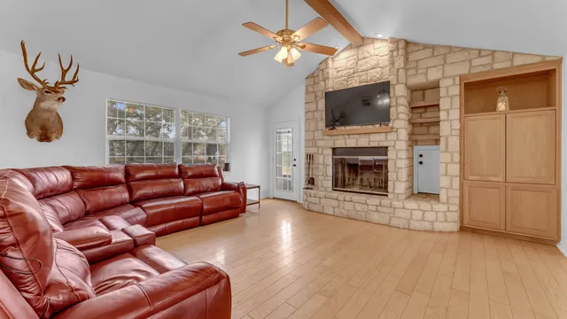a living room with furniture flat screen tv and a fireplace