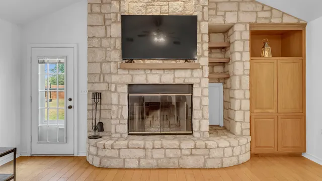 a living room with a fireplace and a flat screen tv
