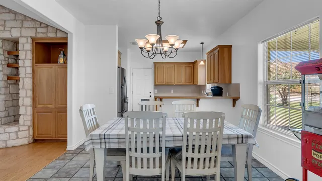a view of a dining room with furniture and a chandelier