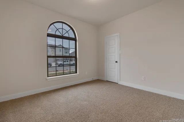 an empty room with windows and closet