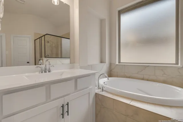 a white bath tub sitting next to a white sink