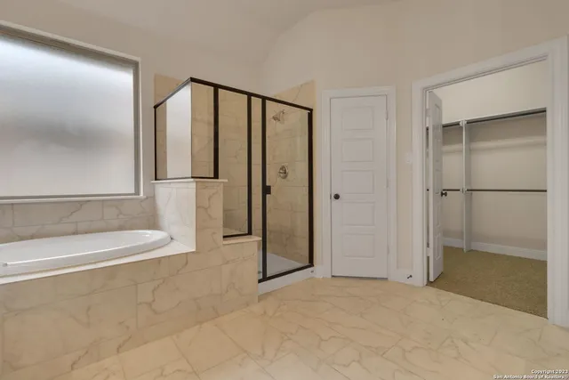 a view of a bathroom with a tub and shower