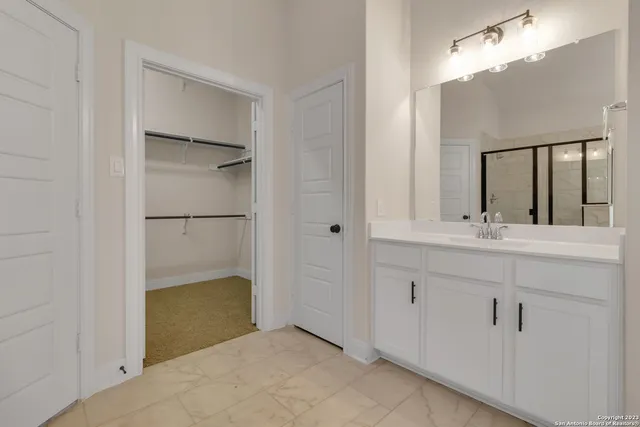 a bathroom with a double vanity sink and a mirror