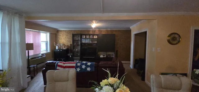 a living room with furniture and a floor to ceiling window