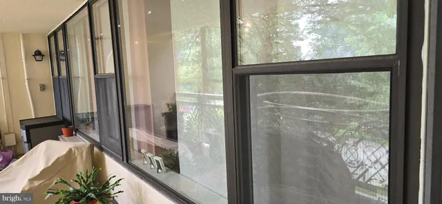 a view of bathroom with a large window and tub