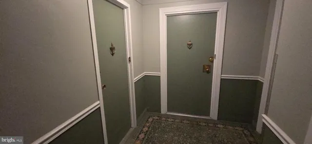 a view of a hallway with wooden shelves