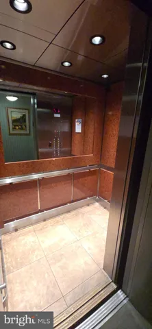 a lobby with furniture and a large mirror