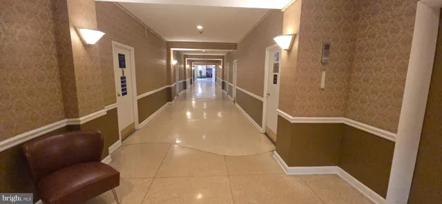 a lobby with furniture and potted plants