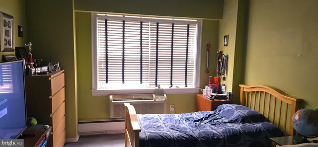 a bedroom with a bed and a window