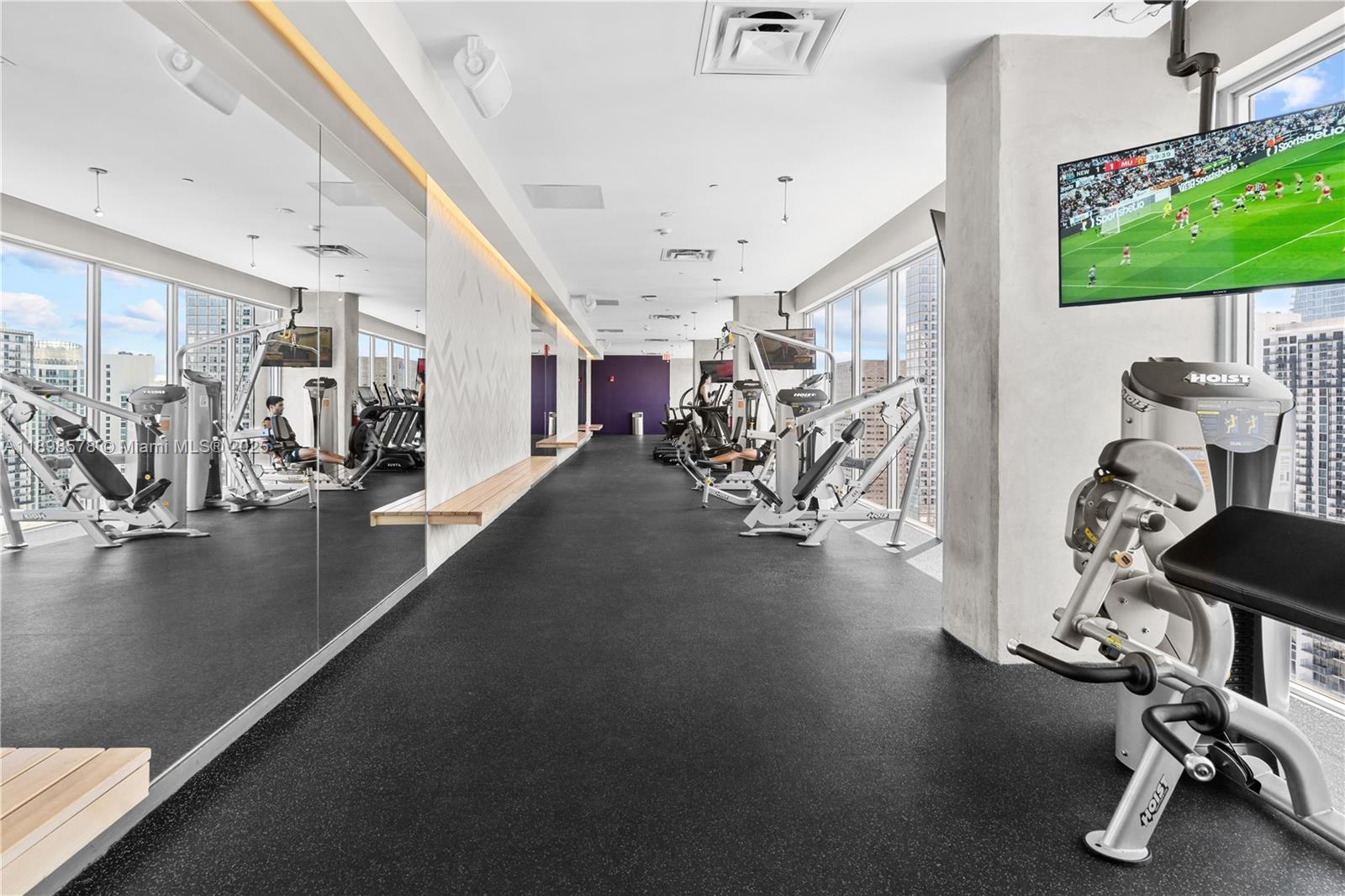 151 Southeast 1st Street, Unit 1402 Miami, FL 33131 - Photo 15 of 16 a view of a room with gym equipment