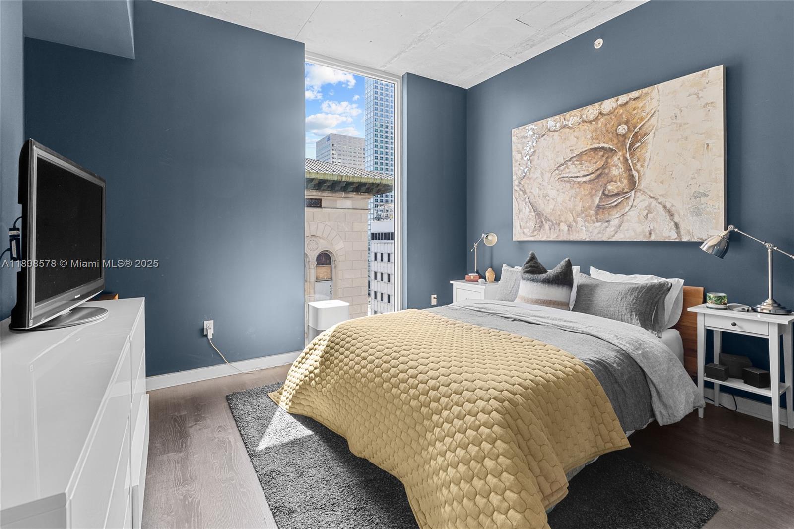 151 Southeast 1st Street, Unit 1402 Miami, FL 33131 - Photo 3 of 16 a bedroom with a bed and a flat screen tv