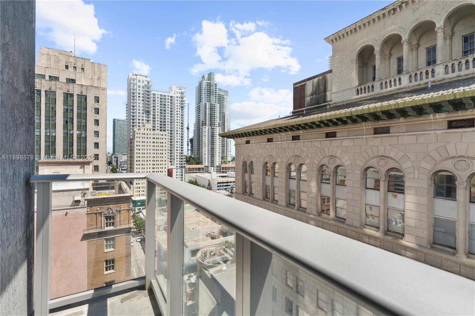 151 Southeast 1st Street, Unit 1402 Miami, FL 33131 - Photo 6 of 16 a view of a building from a balcony