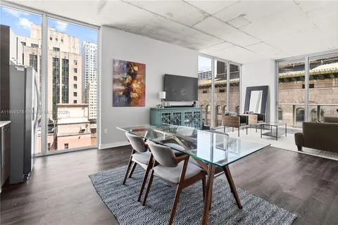 a dining room with furniture and wooden floor