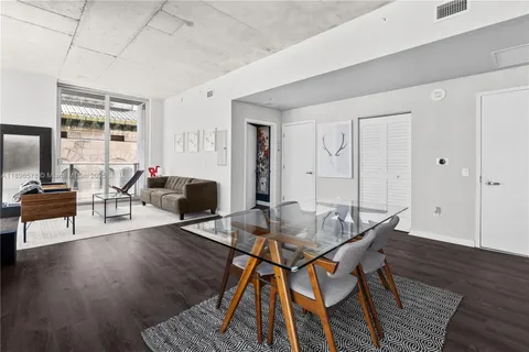 a view of a livingroom with furniture and a dining table chair