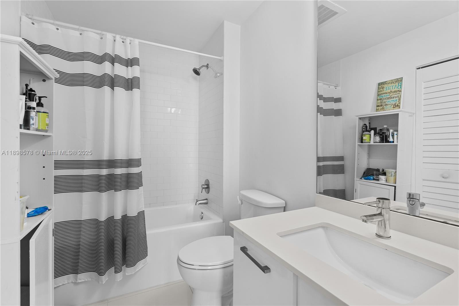151 Southeast 1st Street, Unit 1402 Miami, FL 33131 - Photo 10 of 16 a bathroom with a sink toilet and shower