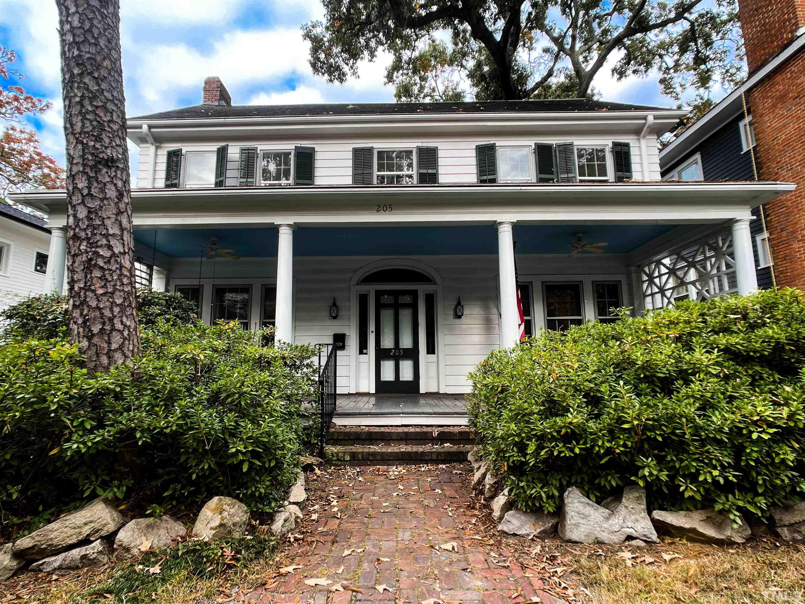 a front view of house with a garden