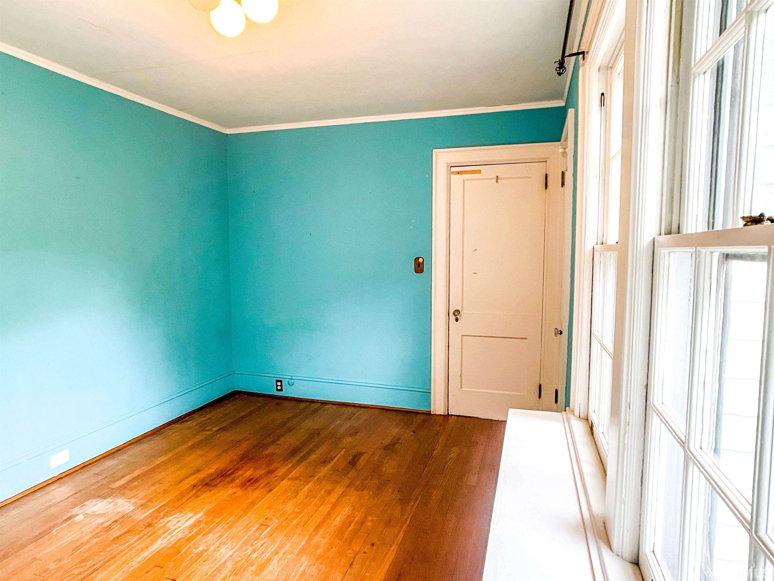 205 Woodburn Road Raleigh, NC 27605 - Photo 22 of 42 a view of a big room with closet and wooden floor
