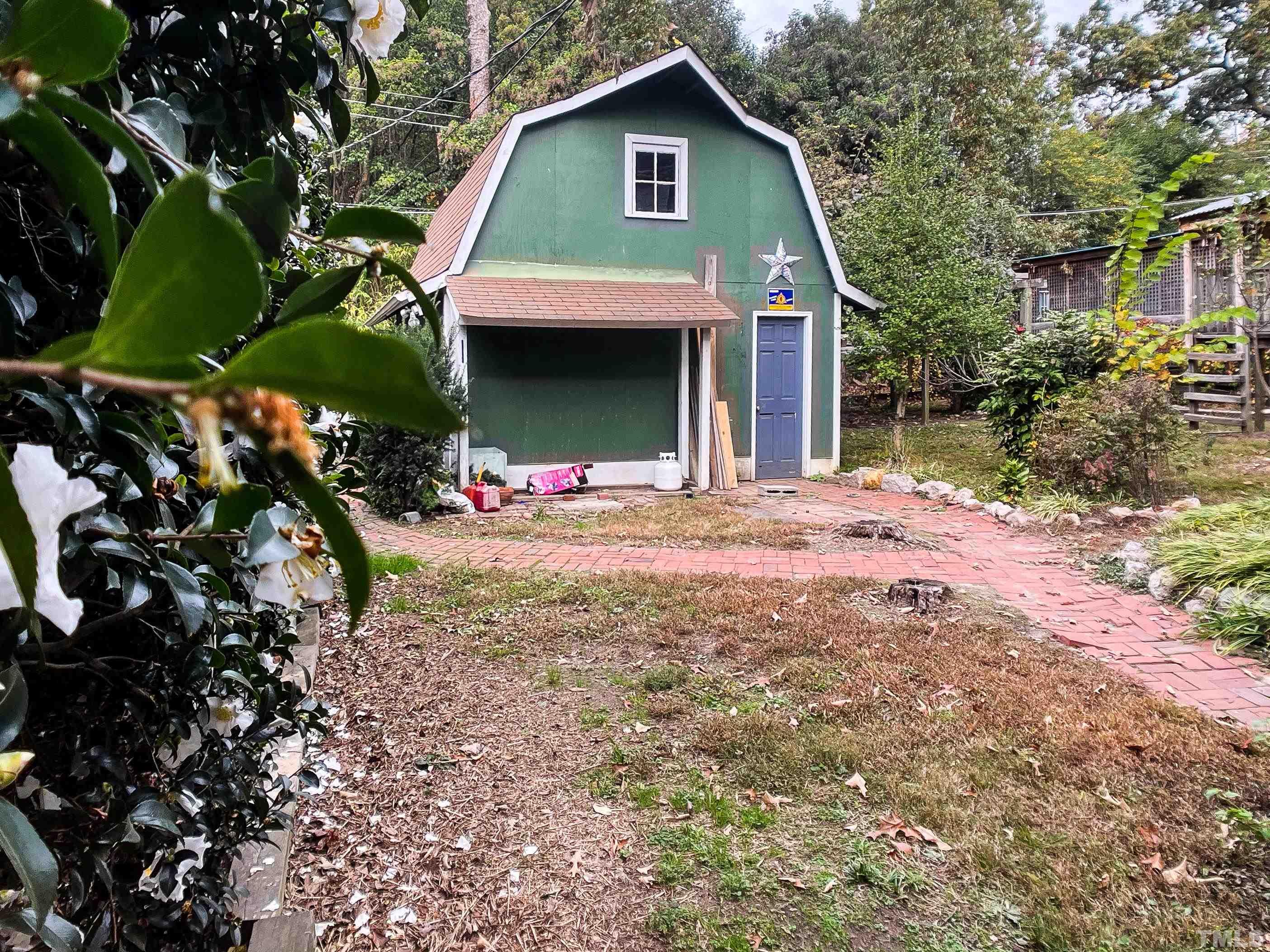 205 Woodburn Road Raleigh, NC 27605 - Photo 35 of 42 a front view of a house with a yard