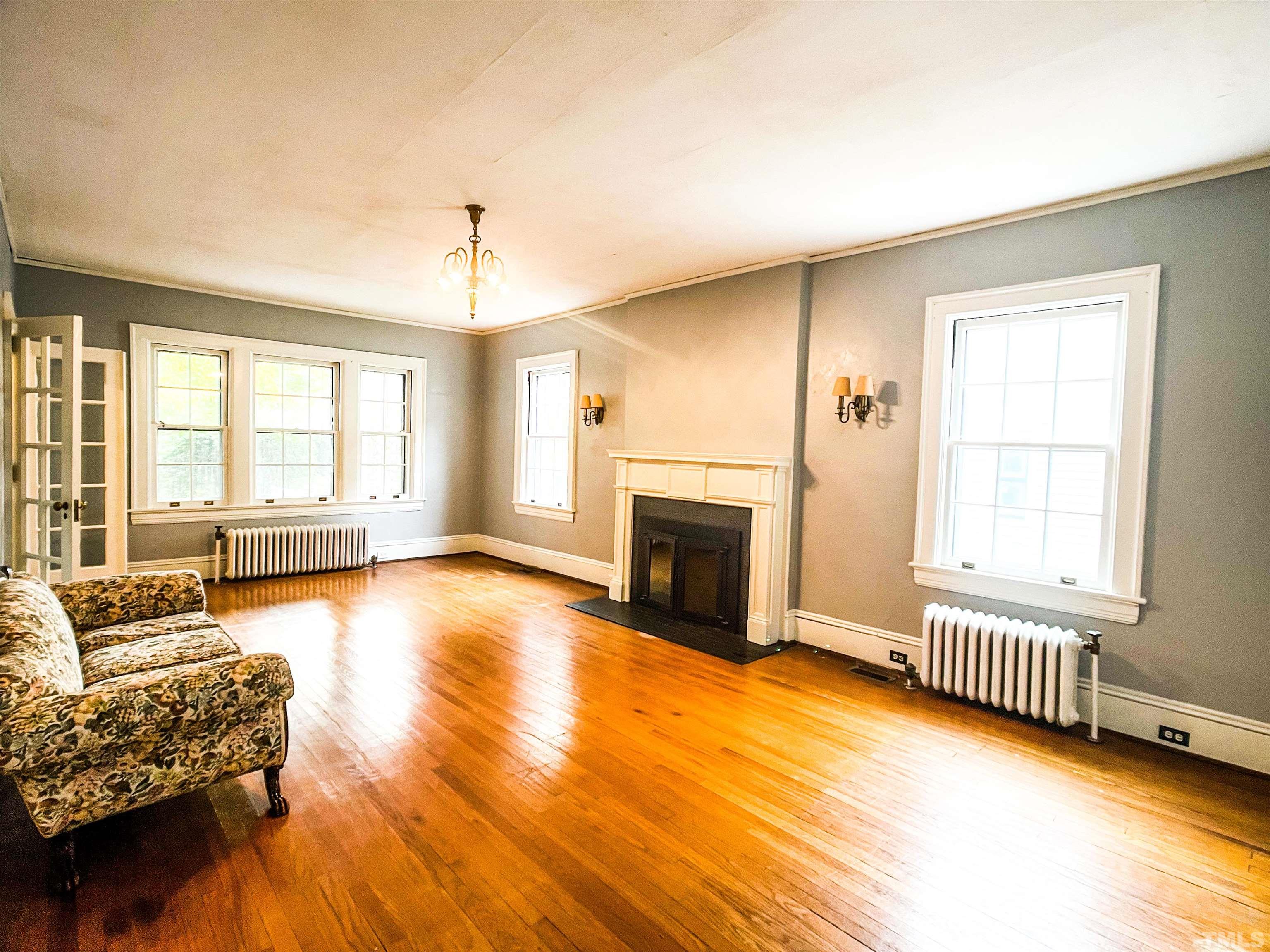 205 Woodburn Road Raleigh, NC 27605 - Photo 7 of 42 a view of a livingroom with furniture wooden floor and windows