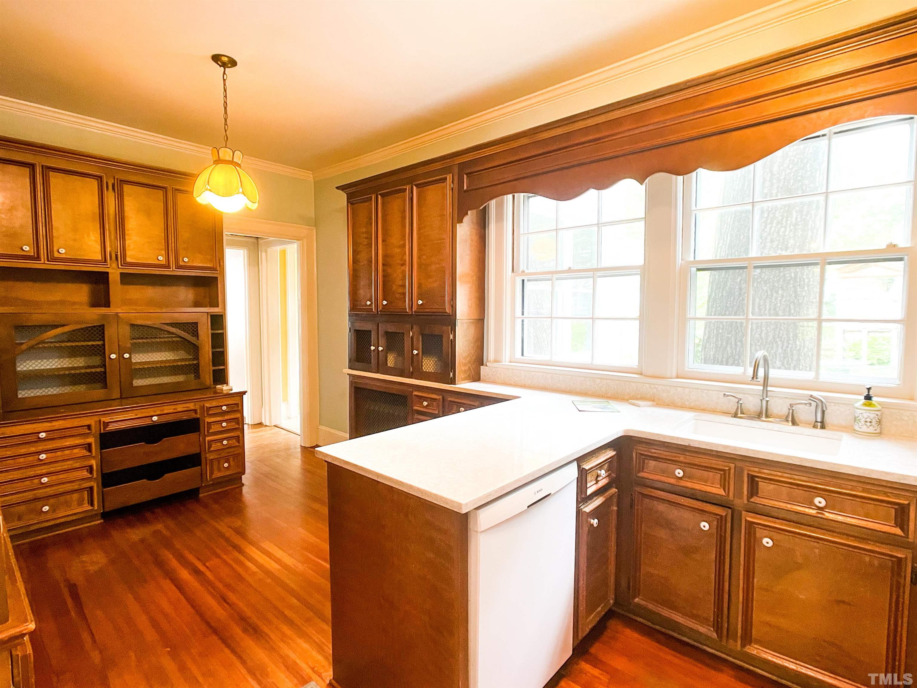 205 Woodburn Road Raleigh, NC 27605 - Photo 10 of 42 a kitchen that has a sink stove and cabinets
