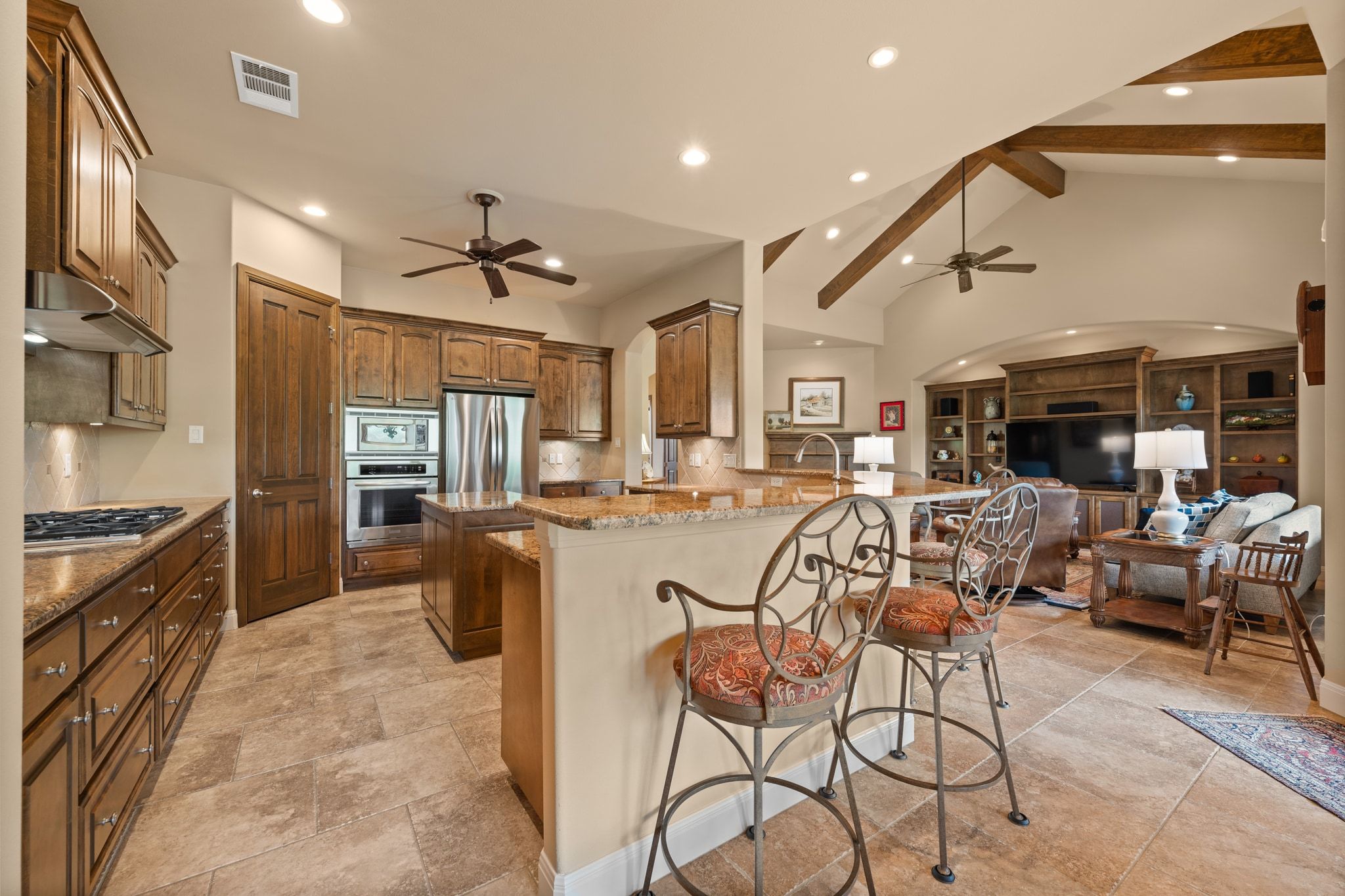 14 Borello Drive, Unit 14 Austin, TX 78738 - Photo 11 of 33 a large kitchen with stainless steel appliances granite countertop a stove and a refrigerator