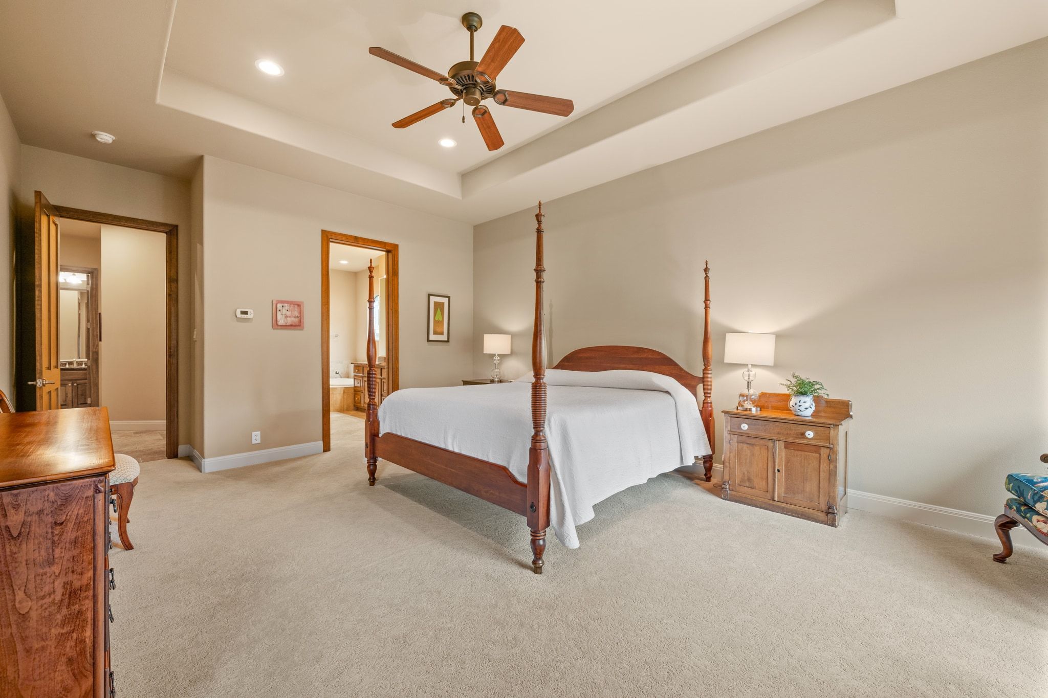 14 Borello Drive, Unit 14 Austin, TX 78738 - Photo 16 of 33 a bedroom with a bed and a chandelier