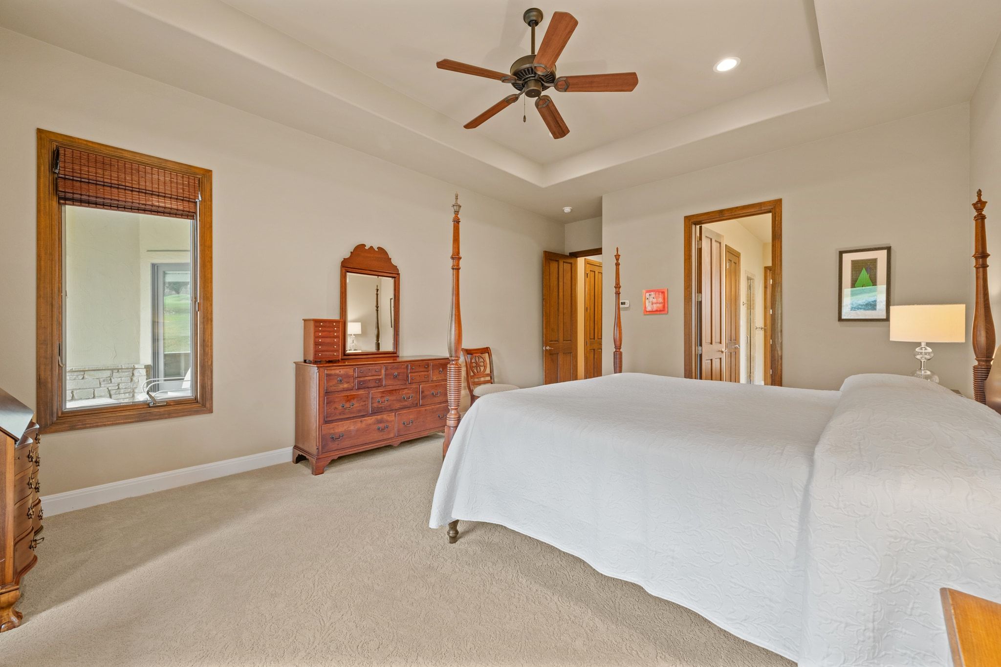 14 Borello Drive, Unit 14 Austin, TX 78738 - Photo 17 of 33 a bedroom with a large bed and a chandelier