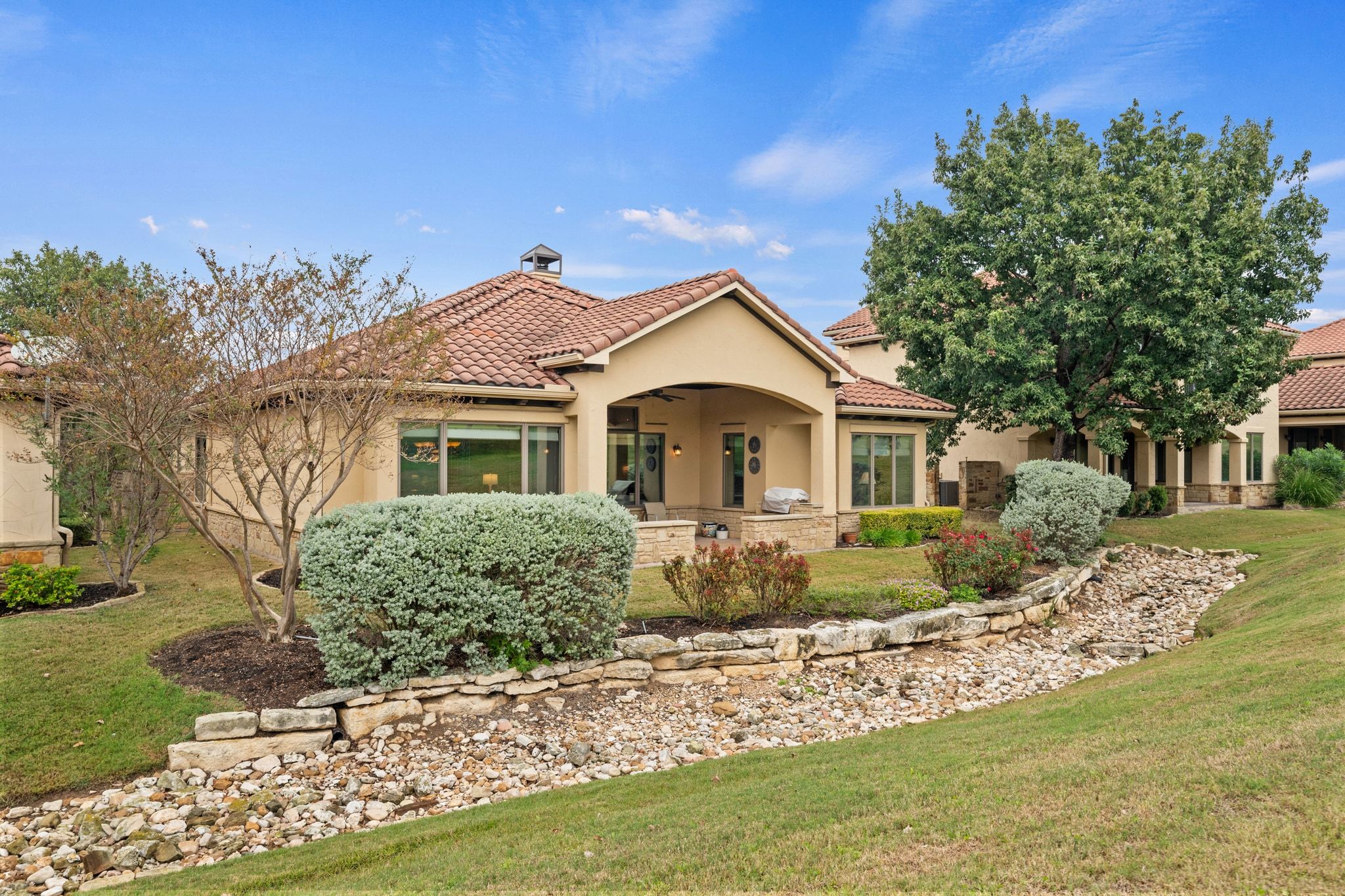 14 Borello Drive, Unit 14 Austin, TX 78738 - Photo 27 of 33 a front view of a house with a garden