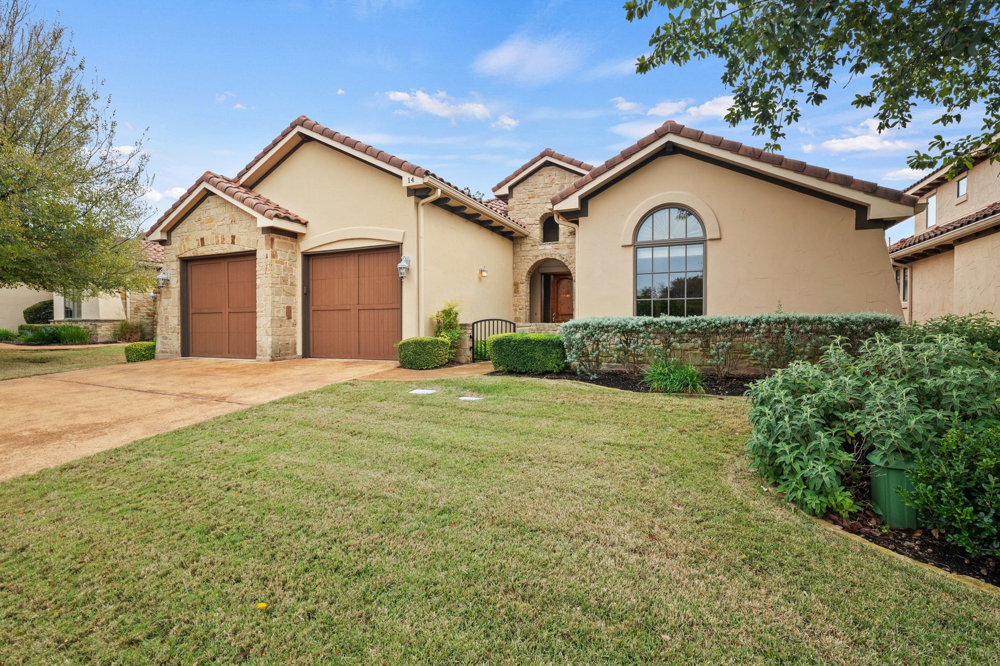 14 Borello Drive, Unit 14 Austin, TX 78738 - Photo 32 of 33 a front view of a house with a yard and garage