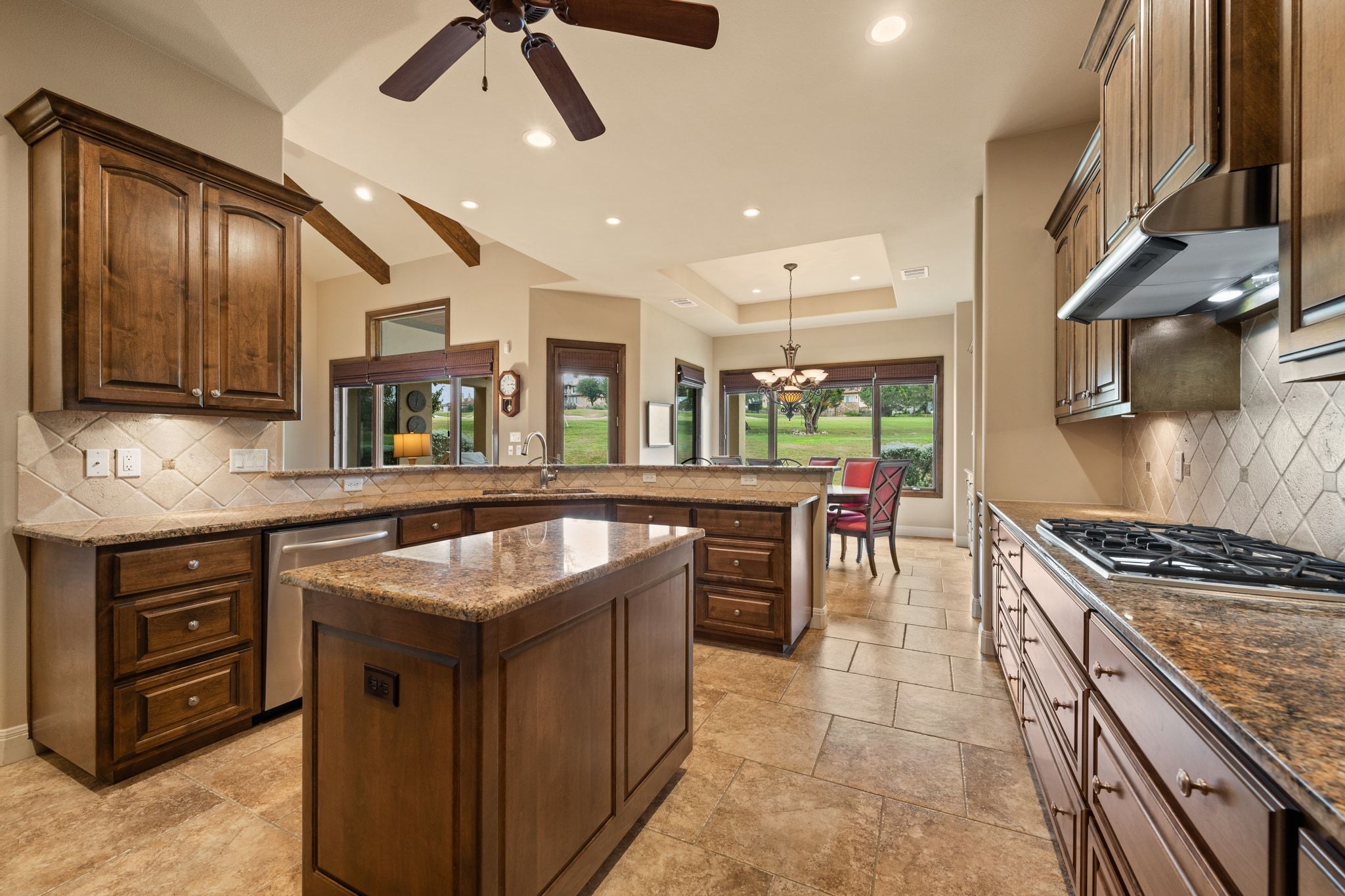 14 Borello Drive, Unit 14 Austin, TX 78738 - Photo 5 of 33 a kitchen with stainless steel appliances granite countertop a stove a sink and a microwave