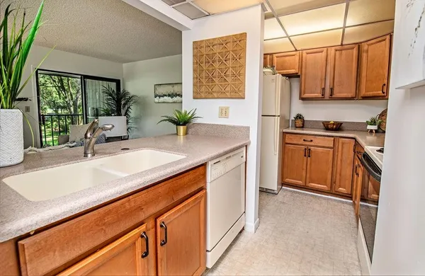 a kitchen with stainless steel appliances granite countertop a sink and cabinets