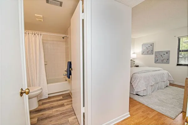 a en suite bathroom with a granite countertop sink and a mirror