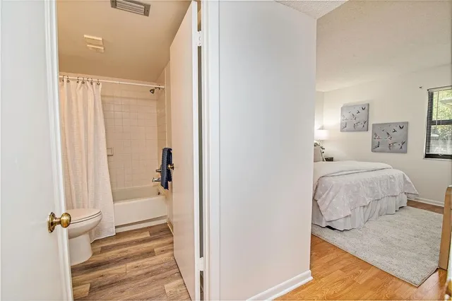 a en suite bathroom with a granite countertop sink and a mirror