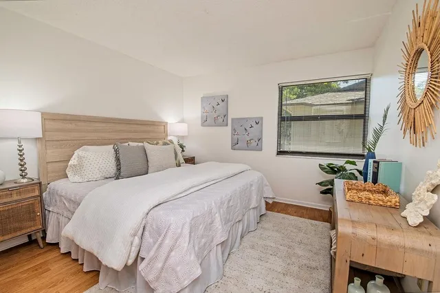 a bedroom with a bed and windows