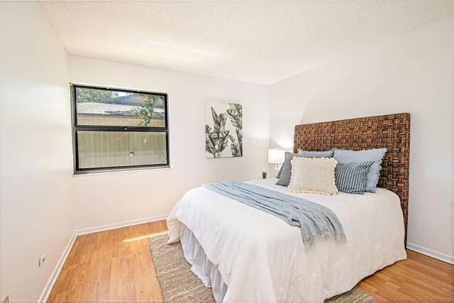 a bedroom with a bed and painting on the wall