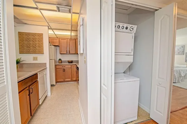 a view of a kitchen with a sink and dishwasher white cabinet