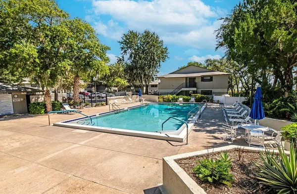 a view of a house with swimming pool and sitting area