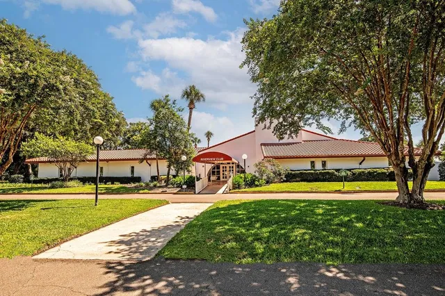 a view of a swimming pool with a patio and a yard