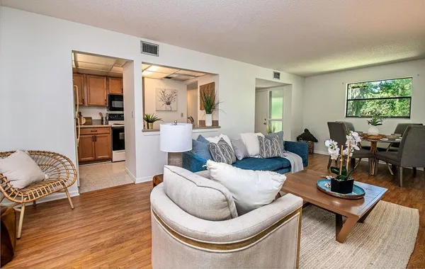 a living room with furniture and wooden floor