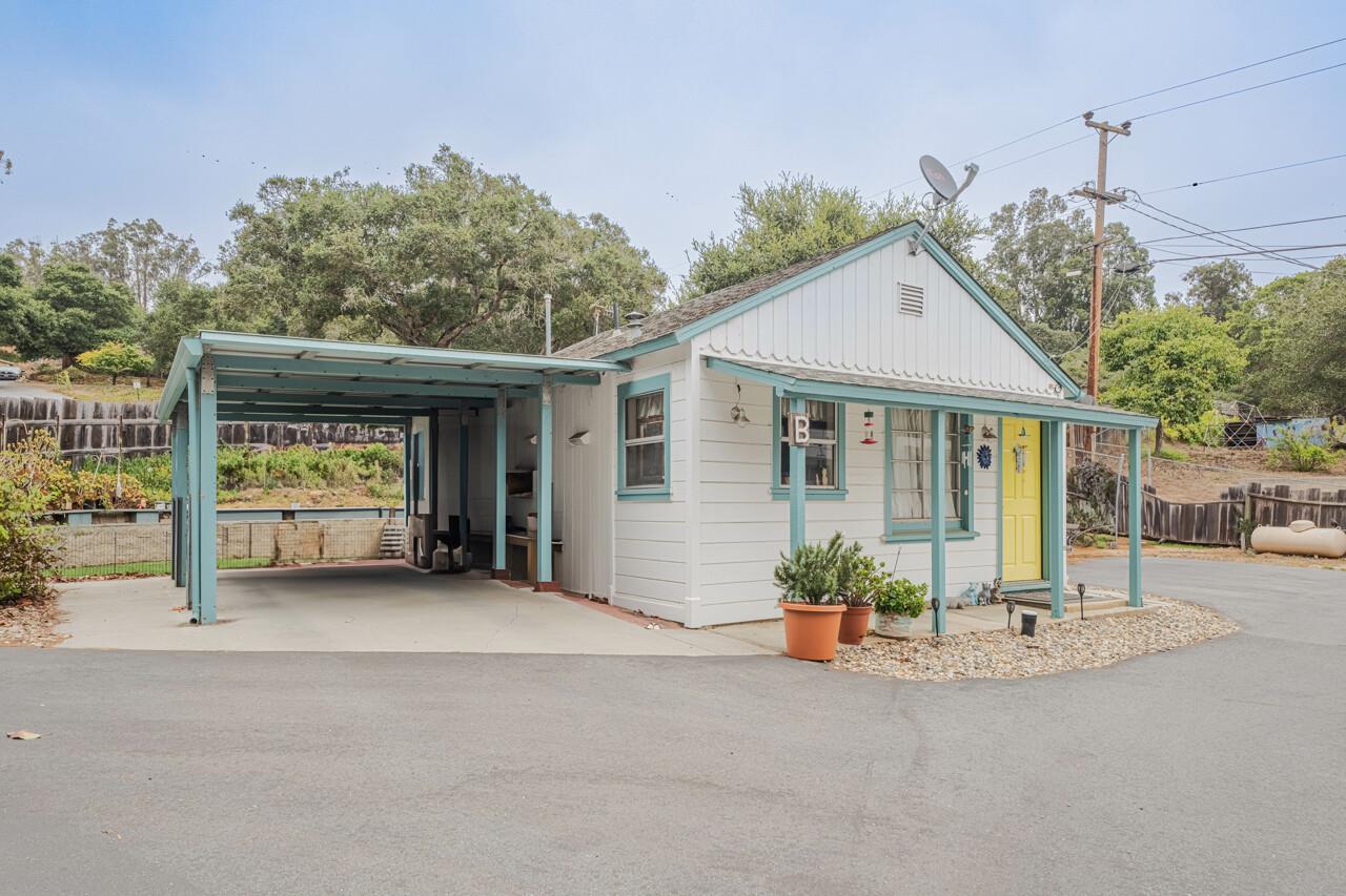 17229 McGuffie Road Prunedale, CA 93907 - Photo 6 of 9 a front view of a house with a porch and potted plants