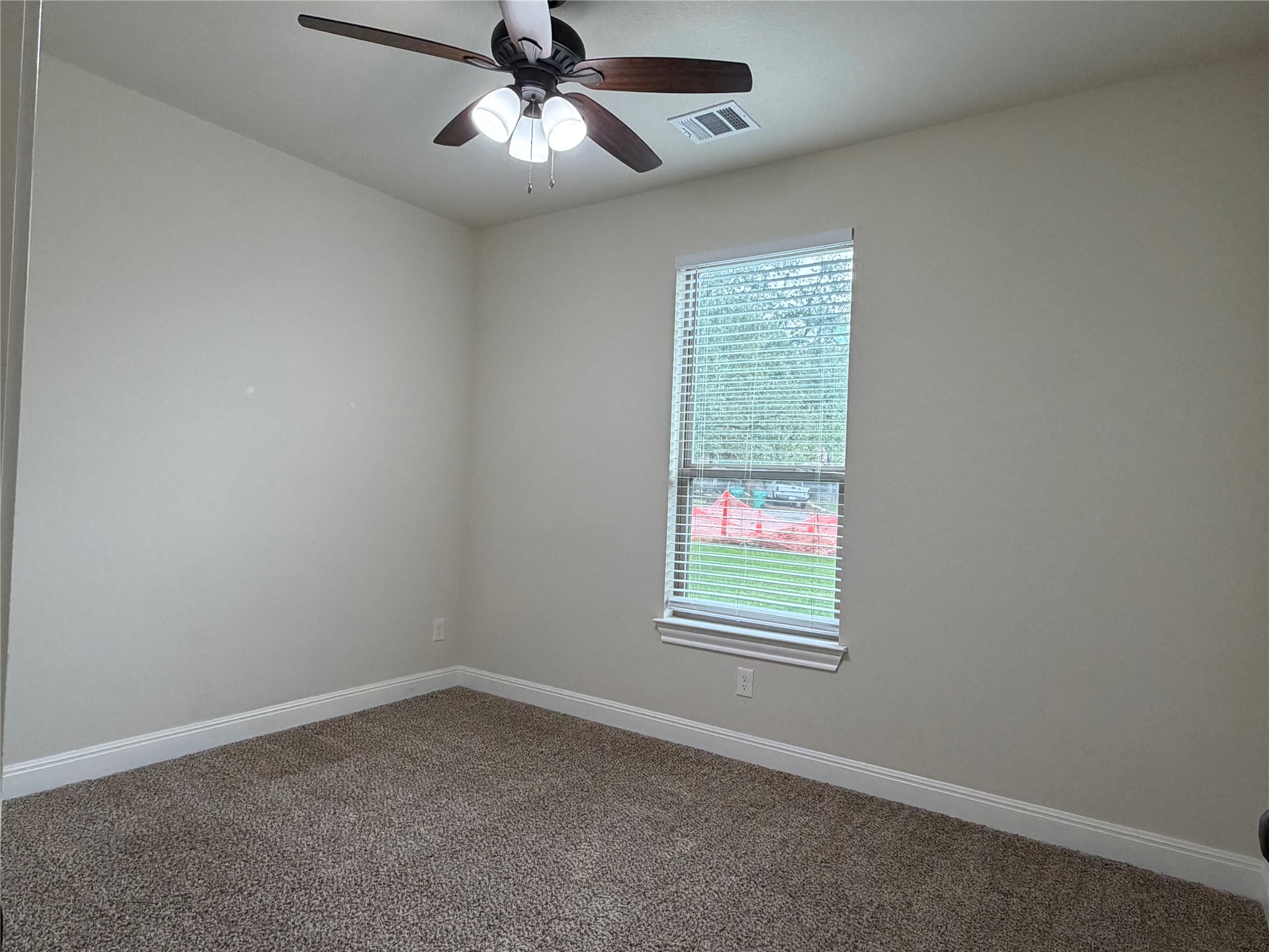 206 Fairway Circle Point Venture, TX 78645 - Photo 13 of 24 an empty room with a window and a fan