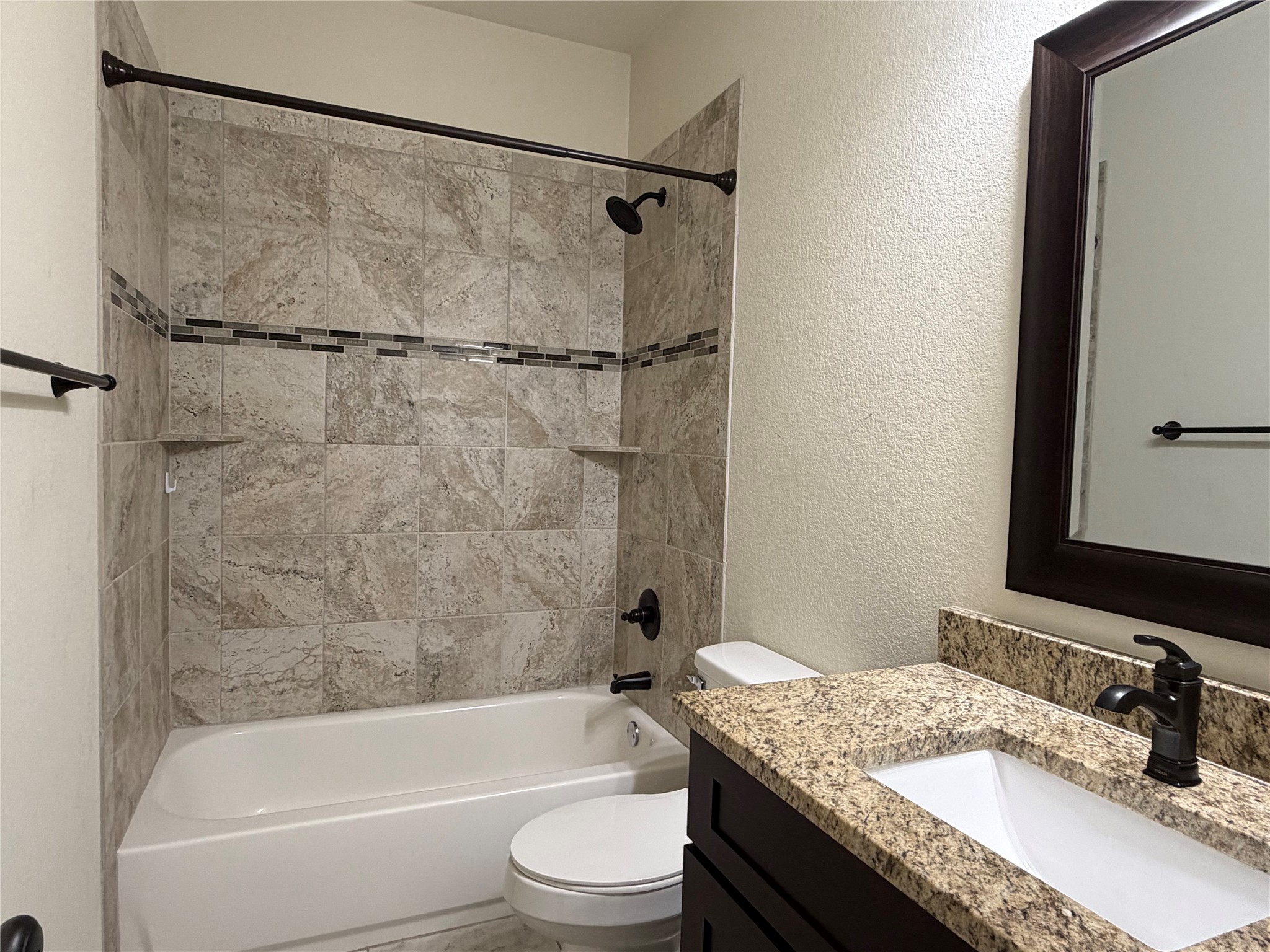 206 Fairway Circle Point Venture, TX 78645 - Photo 14 of 24 a bathroom with a granite countertop bathtub shower sink vanity and toilet