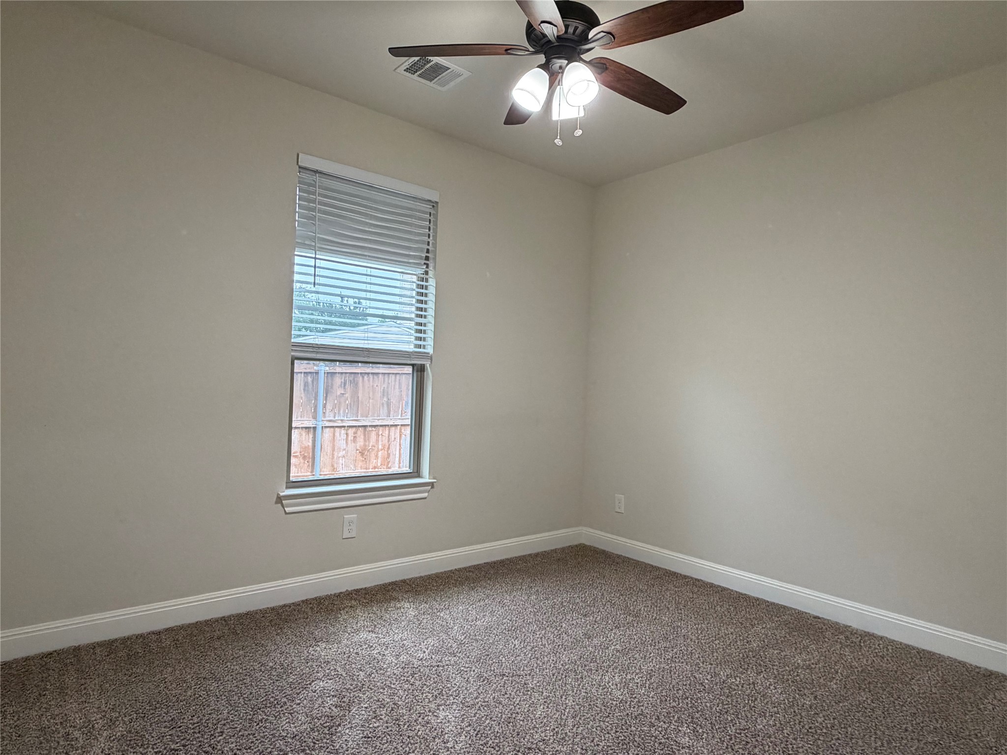 206 Fairway Circle Point Venture, TX 78645 - Photo 15 of 24 an empty room with a window and a fan