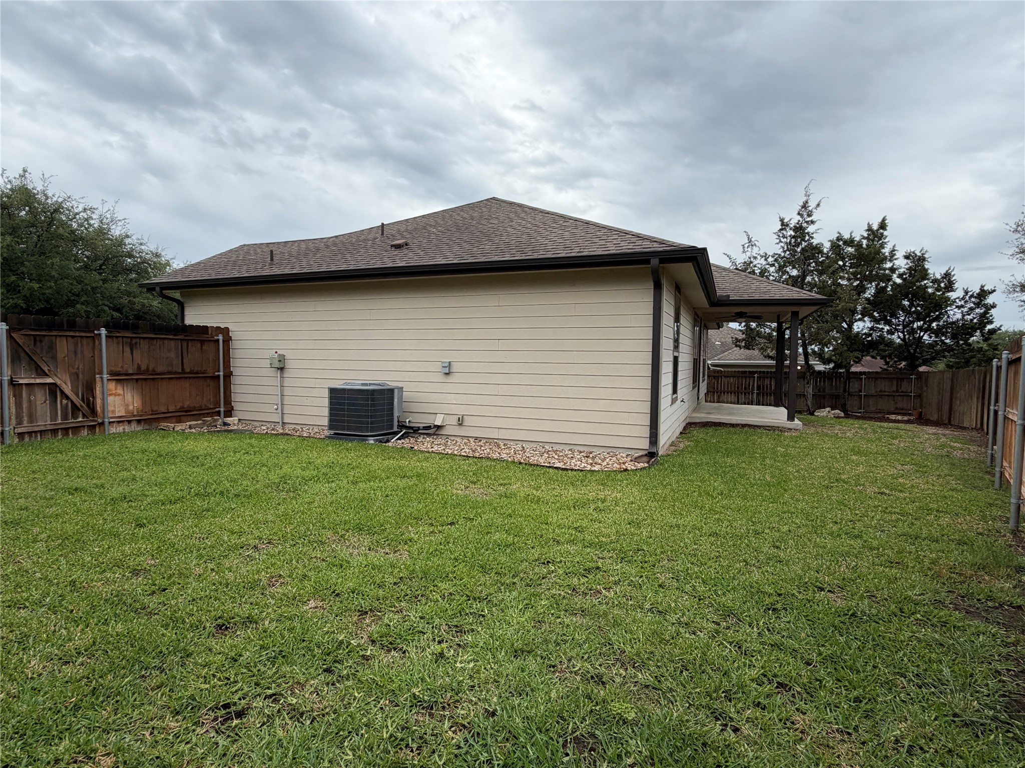 206 Fairway Circle Point Venture, TX 78645 - Photo 18 of 24 a backyard of a house with lots of green space