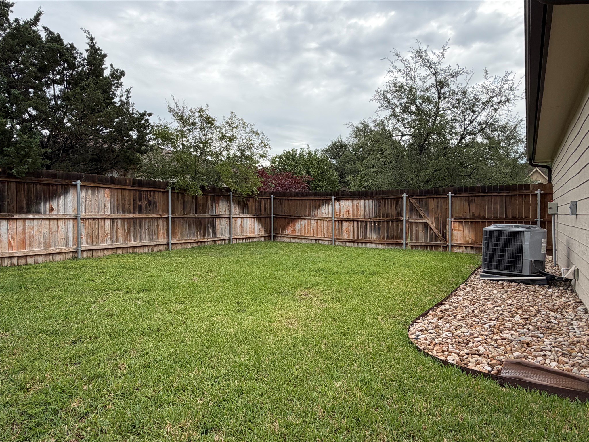 206 Fairway Circle Point Venture, TX 78645 - Photo 2 of 24 a view of a backyard with a garden